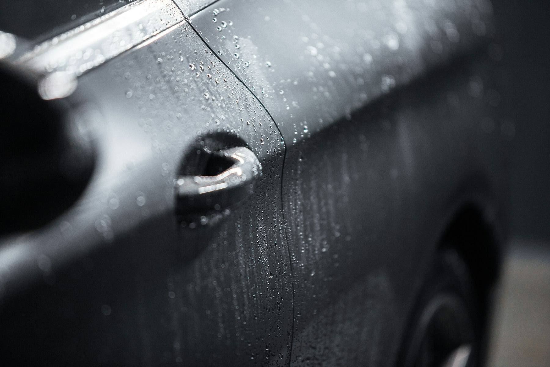 Water beading tightly on black ceramic-coated paint
