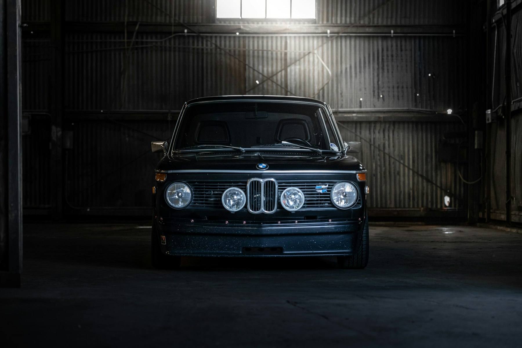 Classic BMW in a dim garage
