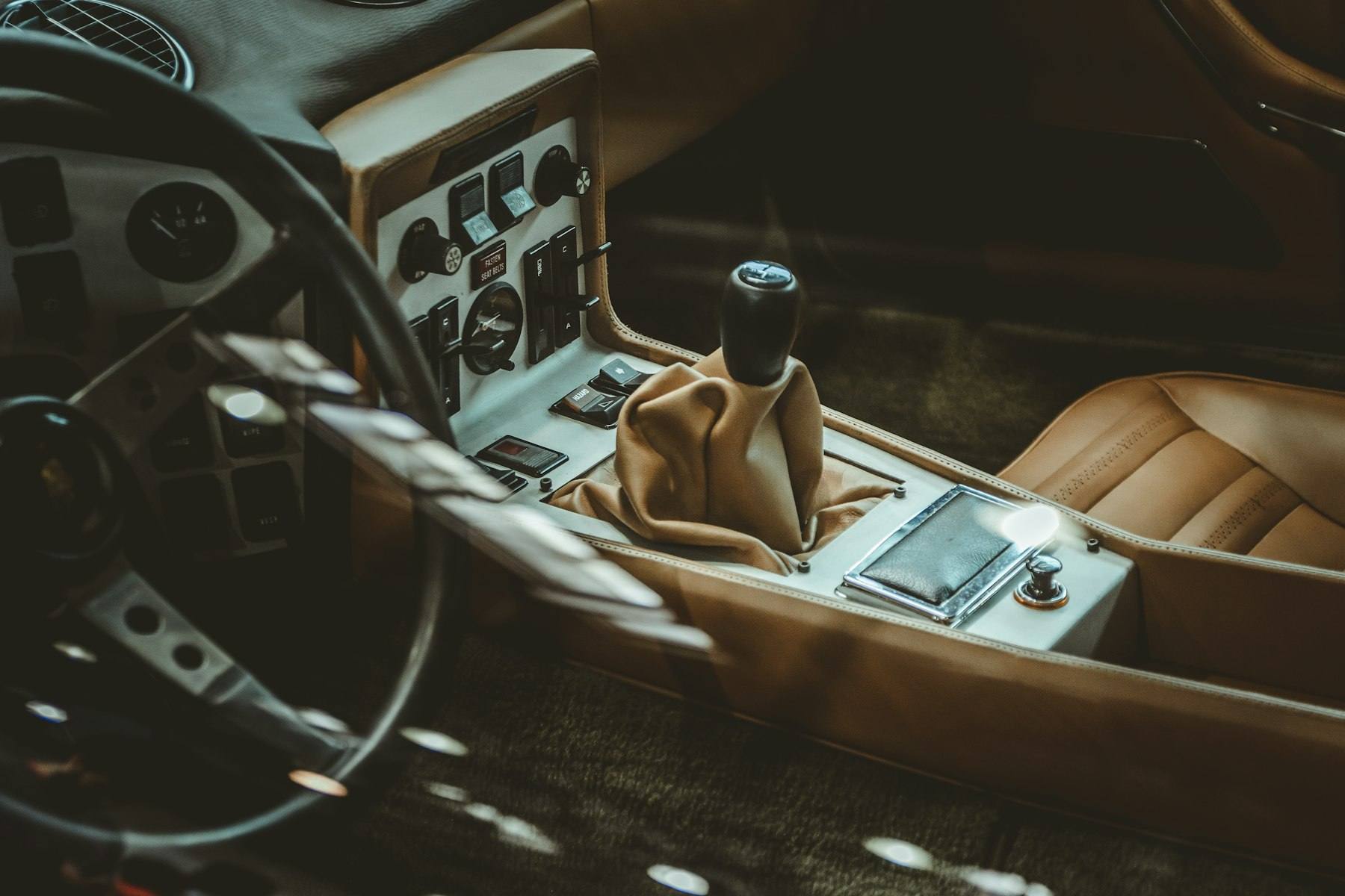 Leather-wrapped gear shifter in a cleaned cabin